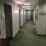 Hallway that leads to the patient treatment rooms in [PRACTICE_NAME] office n [CITY] [STATE], where a range of [SPECIALTY] treatments and surgeries are performed.